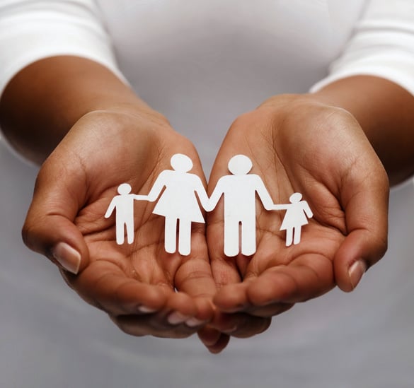 Female Hands holding a Paper Family